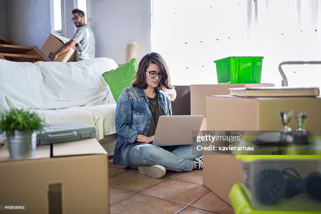 Woman using laptop at the new home