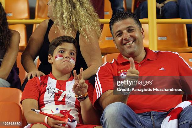 Father and son, supporters of Olympiacos, pose for a photo during the Turkish Airlines Euroleague Basketball Regular Season Date 1 game Olympiacos...