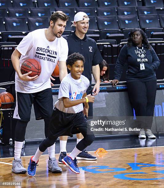 Sergey Karasev of the Brooklyn Nets coaches kids during the Jr. NBA clinic on October 11, 2015 at Barclays Center in Brooklyn, NY. NOTE TO USER: User...