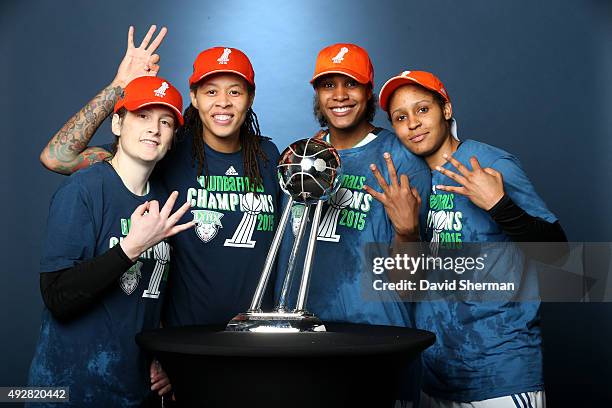 Lindsay Whalen, Seimone Augustus, Rebekkah Brunson, and Maya Moore of the Minnesota Lynx poses with the WNBA trophy after defeating the Indiana Fever...