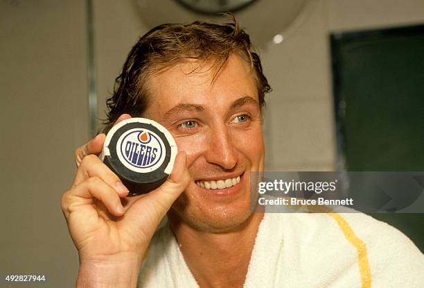 Wayne Gretzky of the Los Angeles Kings poses with the 1,851 puck that Gretkzy scored with to pass Gordie Howe as the all-time point leader in the NHL...