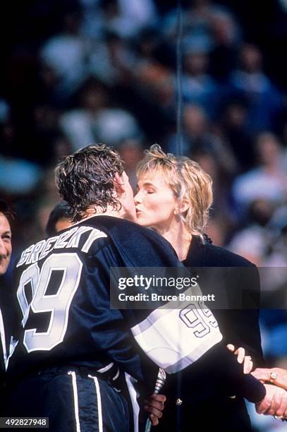 Wayne Gretzky of the Los Angeles Kings kisses his wife Janet Jones after he scored his 1851st career NHL point against the Edmonton Oilers on October...