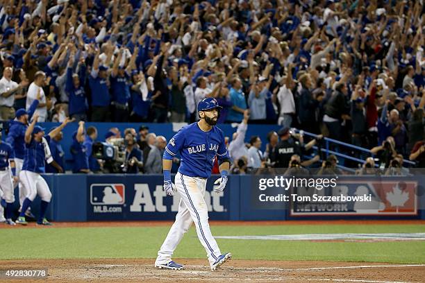 Jose Bautista of the Toronto Blue Jays watches after he he hits a three-run home run in the seventh inning against the Texas Rangers in game five of...