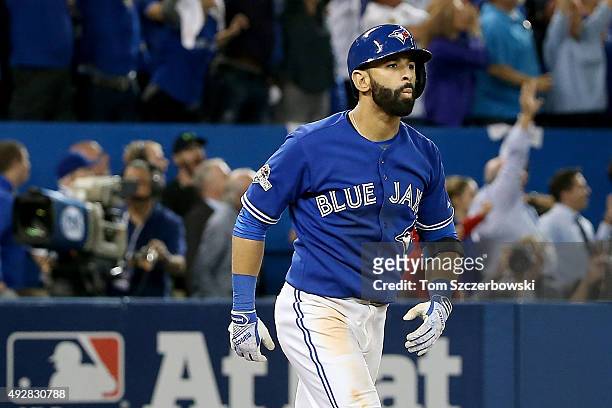 Jose Bautista of the Toronto Blue Jays watches after he he hits a three-run home run in the seventh inning against the Texas Rangers in game five of...