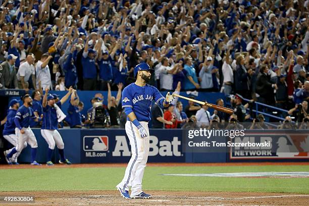 Jose Bautista of the Toronto Blue Jays flips his bat up in the air after he hits a three-run home run in the seventh inning against the Texas Rangers...