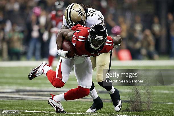 Julio Jones of the Atlanta Falcons is brought down by Dannell Ellerbe of the New Orleans Saints during the second quarter of a game at the...