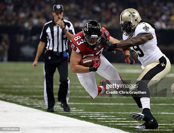 Jacob Tamme of the Atlanta Falcons is pushed out of bounds by Dannell Ellerbe of the New Orleans Saints during the second quarter of a game at the...