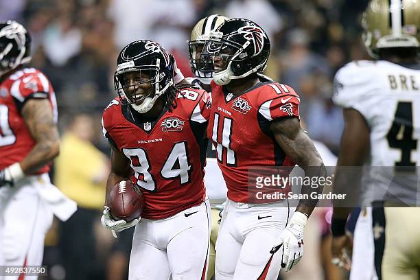 Roddy White is congratulated by Julio Jones of the Atlanta Falcons following a touchdown in the second quarter of a game against the New Orleans...