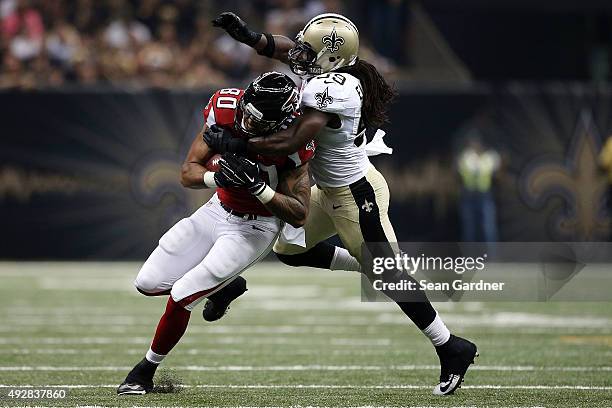 Levine Toilolo of the Atlanta Falcons is brought down by Dannell Ellerbe of the New Orleans Saints during the second quarter of a game at the...