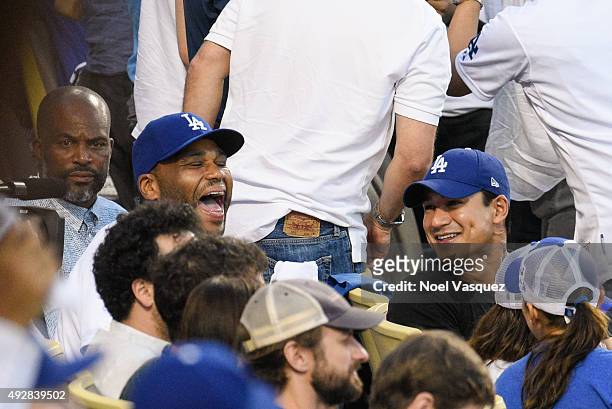 Anthony Anderson and Mario Lopez attend game five of the National League Division Series between the New York Mets and the Los Angeles Dodgers at...