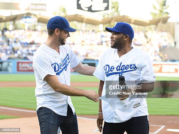 Zach Levi and Anthony Anderson attend game five of the National League Division Series between the New York Mets and the Los Angeles Dodgers at...