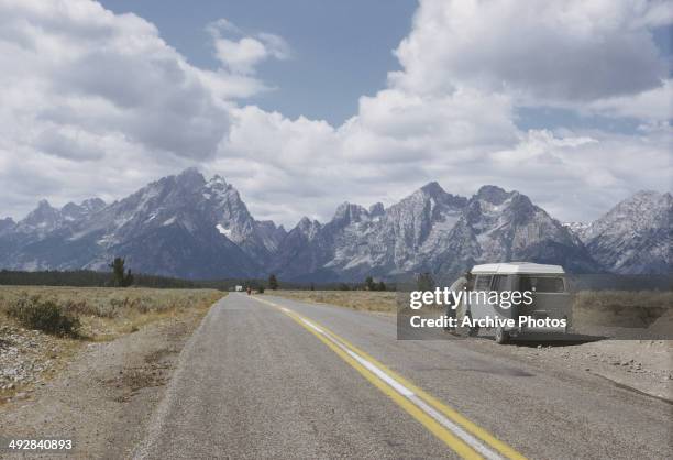 Camper van near the Teton Range of the Rocky Mountains in Wyoming, USA, circa 1965.