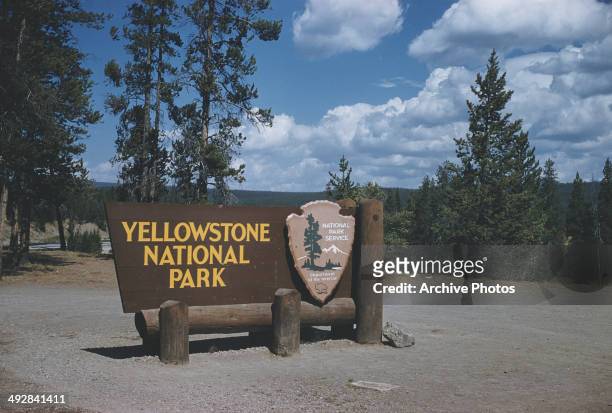 Sign at the south entrance to Yellowstone National Park, Wyoming, courtesy of the National Park Service, Department of the Interior, USA, circa 1965.