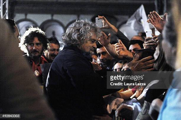 Beppe Grillo, Italian comedian, blogger and political leader of the Movimento 5 Stelle , greets people after speaking during a political rally before...