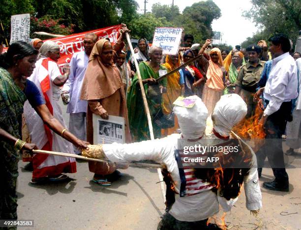 Relatives of Indian victims of the 1984 Bhopal Gas Tragedy burn an effigy of US Union Carbide Chairman Warren Anderson at a demonstration in Bhopal,...