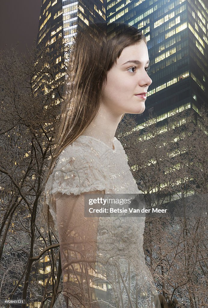 Digital composite of young woman and city.