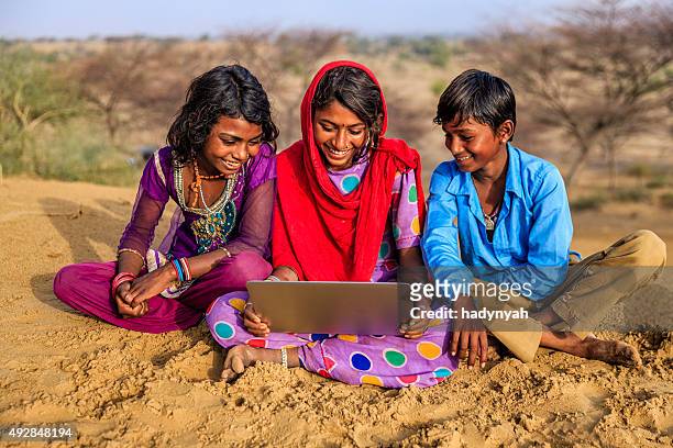 happy indian children using laptop, desert village, india - rural scene stock pictures, royalty-free photos & images