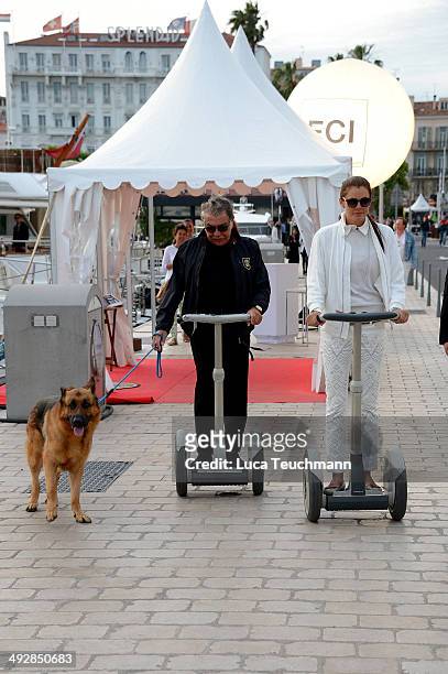 Roberto Cavalli and Lina Nilson ride on segways on day 8 of the 67th Annual Cannes Film Festival on May 21, 2014 in Cannes, France.