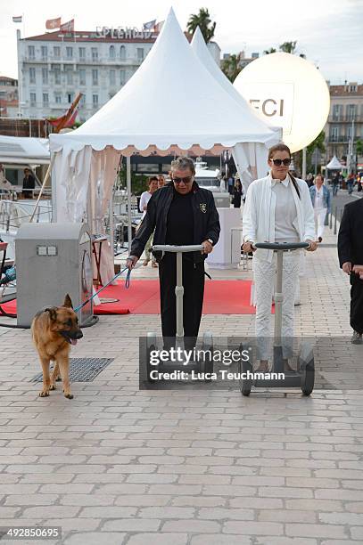 Roberto Cavalli and Lina Nilson ride on segways on day 8 of the 67th Annual Cannes Film Festival on May 21, 2014 in Cannes, France.