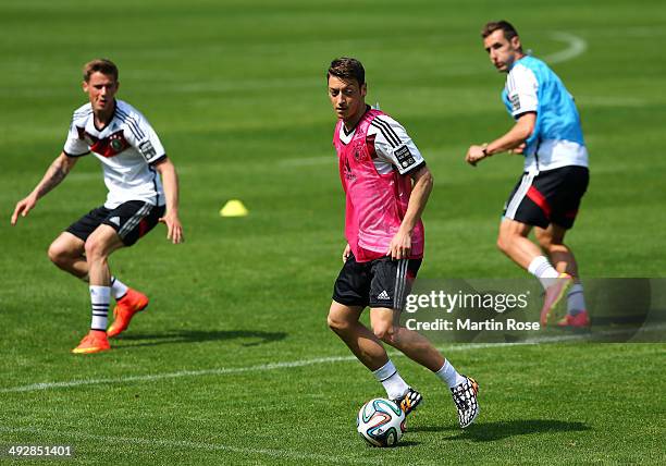 Mesut Oezil runs with the ball during the German National team training session at St.Martin training ground on May 22, 2014 in St.Martin in...