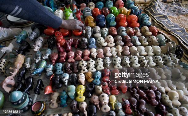 Kenyan seller displays his wares on May 22, 2014 at the Maasai market in Nairobi a few days after hundreds of British tourists have been evacuated...