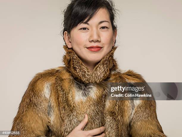 southeast asian woman in fur coat - abrigo de pieles fotografías e imágenes de stock