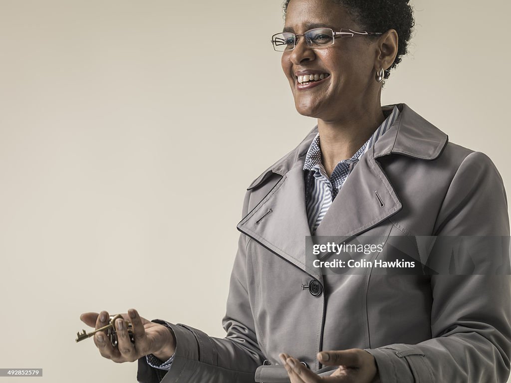 Black woman in coat holding keys
