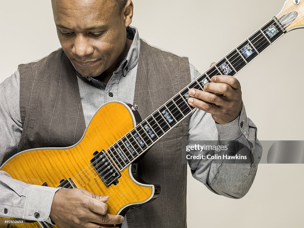 Black male playing guitar
