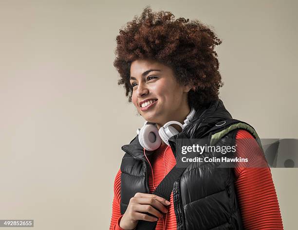 young black female wearing headphones - ärmellos stock-fotos und bilder