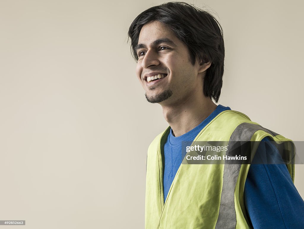 Asian man wearing high visibility jacket
