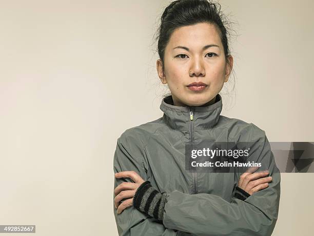 southeast asian female in sports jacket - abrigo gris fotografías e imágenes de stock