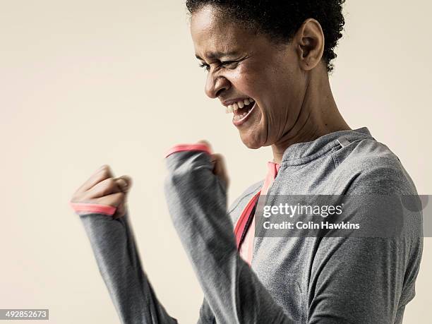 black woman celebrating in exercise top - punching the air stock pictures, royalty-free photos & images