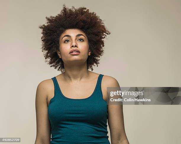 young woman looking up - green vest stock pictures, royalty-free photos & images