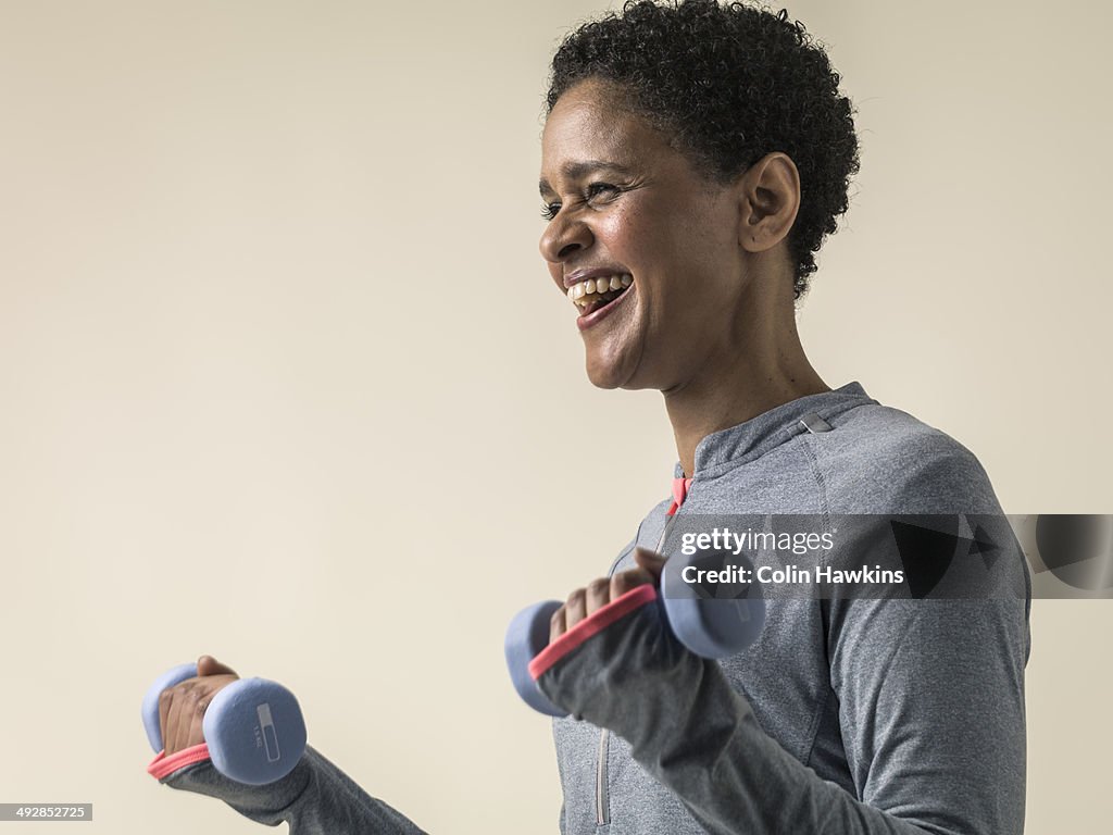 Black woman exercising with weights