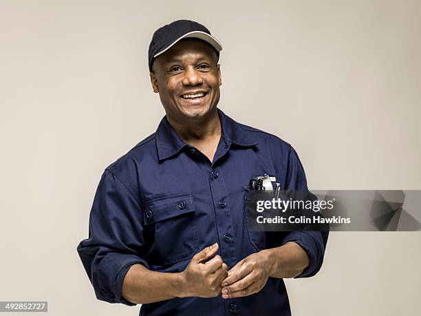 black male in work clothes - blue collar portrait stock-fotos und bilder