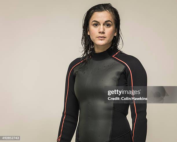 young woman in wetsuit - neoprenanzug stock-fotos und bilder