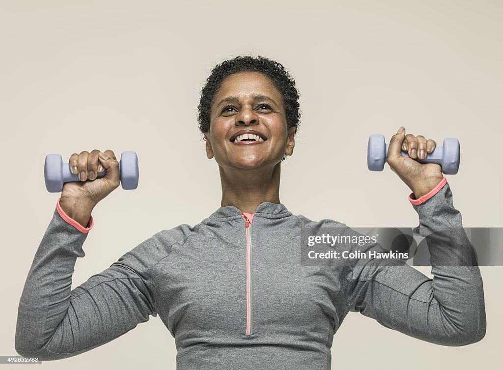 Black woman exercising with weights