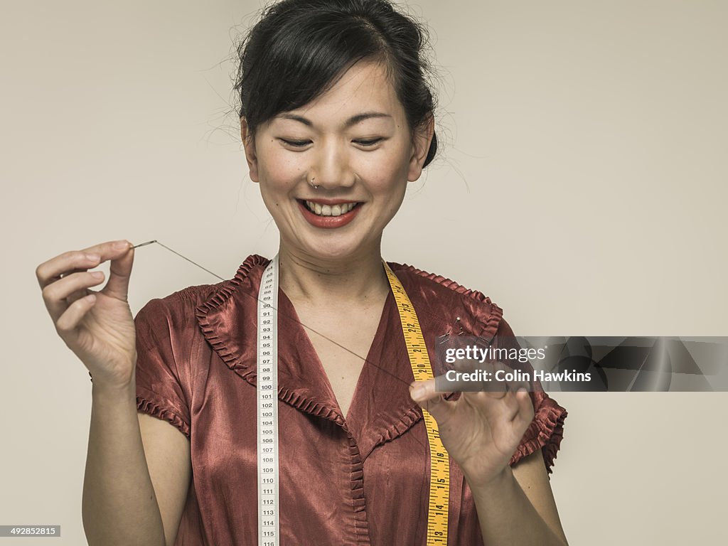 Southeast Asian woman sewing