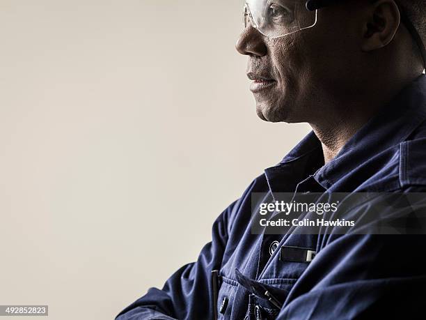 black male in protective work clothes - construction worker pose stock pictures, royalty-free photos & images