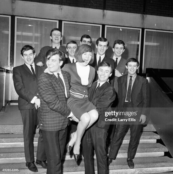 Portrait of bands 'Billy J Kramer and the Dakotas' and 'Gerry and the Pacemakers', holding up the singer Cilla Black, March 23rd 1964.