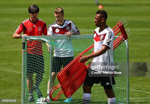 Head coach Joachim Loew talks to Marco Reus during the German National team training session at St.Martin training ground on May 22, 2014 in...
