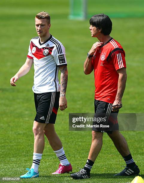 Head coach Joachim Loew talks to Marco Reus during the German National team training session at St.Martin training ground on May 22, 2014 in...