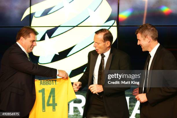 Socceroos Head Coach Ange Postecoglou presents Socceroos jerseys to Prime Minister of Australia Tony Abbott and NSW Premier Mike Baird during the...