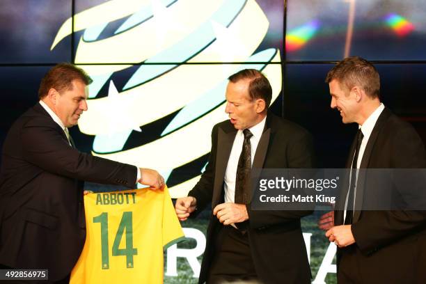 Socceroos Head Coach Ange Postecoglou presents Socceroos jerseys to Prime Minister of Australia Tony Abbott and NSW Premier Mike Baird during the...