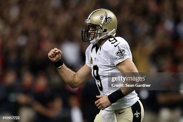 Drew Brees of the New Orleans Saints reacts to a score during the third quarter of a game against the Atlanta Falcons at the Mercedes-Benz Superdome...