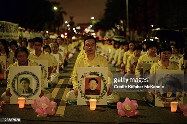 Members of the Falun Gong aka Falun Dafa spiritual group attend a silent protest outside of the Chinese Consulate on October 15, 2015 in Los Angeles,...