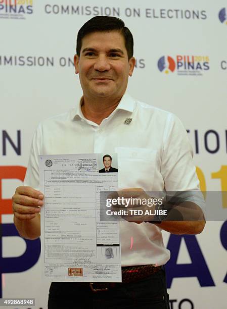 Philippine TV personality and film actor Edu Manzano shows his certificate of candidacy for senator at the Commission on Elections in Manila on...