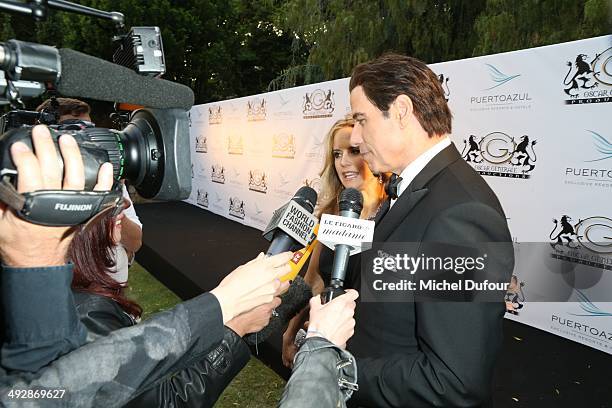 Kelly Preston and John Travolta attend the Puerto Azul Experience: Inside Party at the 67th Annual Cannes Film Festival on May 21, 2014 in Cannes,...