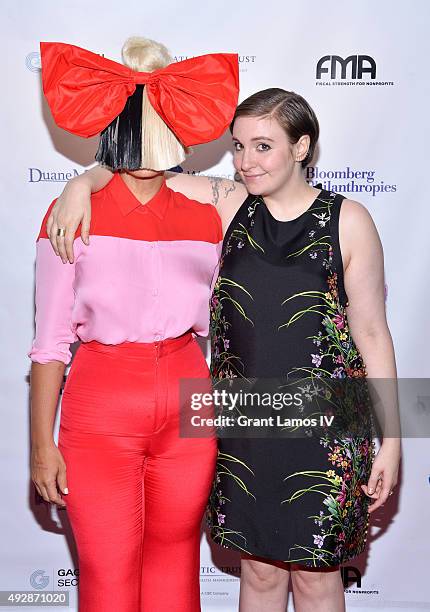 Sia and Lena Dunham attend the GEMS' 2015 Love Revolution Gala at Pier 59 on October 15, 2015 in New York City.