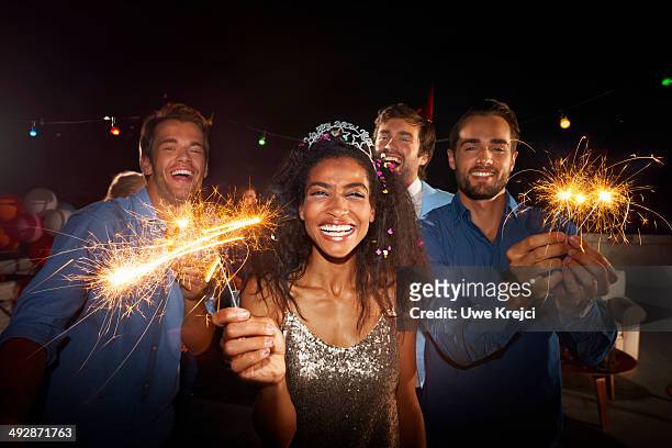 friends celebrating at new year's eve party - sparklers stock pictures, royalty-free photos & images